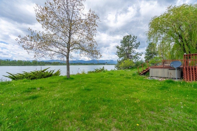 472 Snow Berry Ln, Usk, WA 99180 - view of green lawn with a deck with water view
