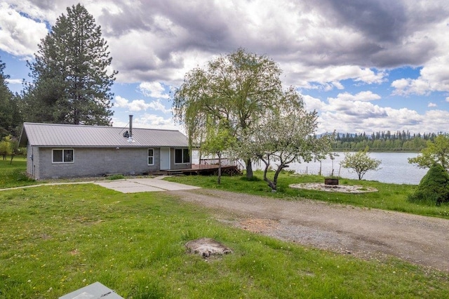 472 Snow Berry Ln, Usk, WA 99180 - rear view of house featuring a water view, a yard, metal roof, and a patio