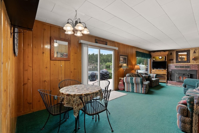 46273 Larson Beach Rd, Loon Lake, WA 99148 - carpeted dining area featuring a chandelier, wooden walls, and a brick fireplace
