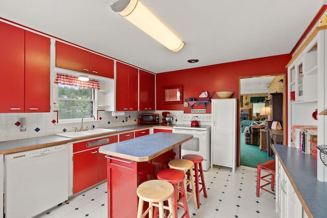 46273 Larson Beach Rd, Loon Lake, WA 99148 - kitchen with red cabinetry, white appliances, light floors, and a sink