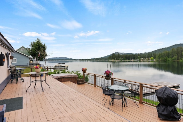 46273 Larson Beach Rd, Loon Lake, WA 99148 - wooden deck featuring a water and mountain view and outdoor dining area