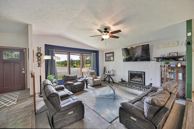 5024 E Ballard Rd, Colbert, WA 99005 - living room featuring lofted ceiling, a ceiling fan, a brick fireplace, a textured ceiling, and wood finished floors
