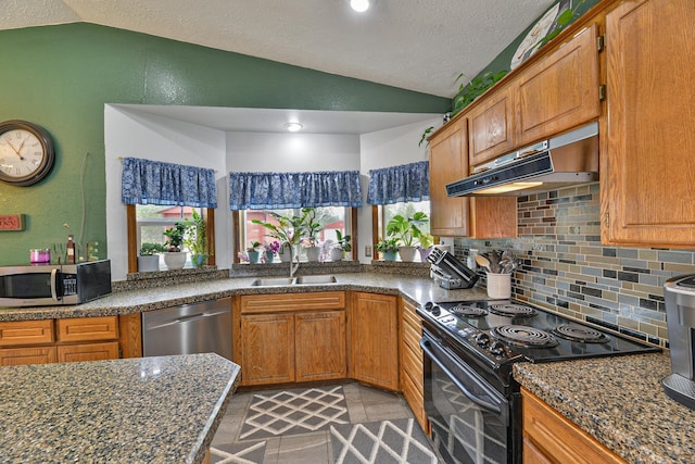 5024 E Ballard Rd, Colbert, WA 99005 - kitchen with appliances with stainless steel finishes, vaulted ceiling, under cabinet range hood, backsplash, and brown cabinetry