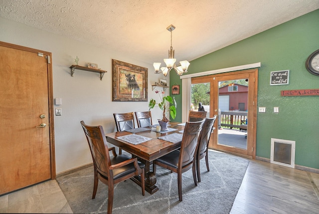 5024 E Ballard Rd, Colbert, WA 99005 - dining space with a chandelier, a textured ceiling, vaulted ceiling, and wood finished floors