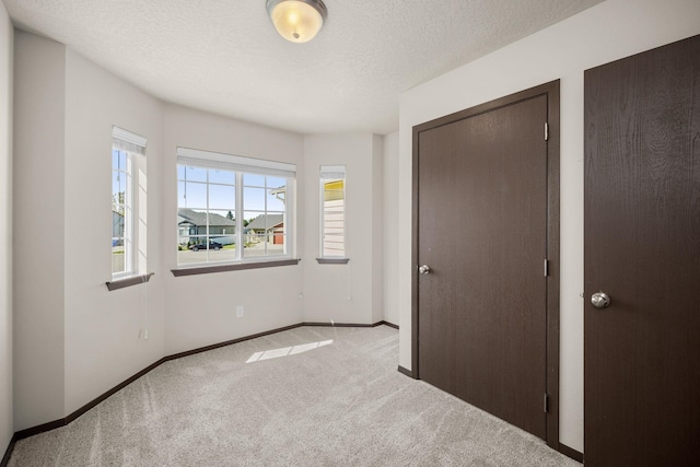 1516 E First Ct, Deer Park, WA 99006 - unfurnished bedroom featuring carpet flooring, baseboards, and a textured ceiling