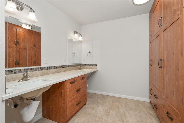 858 S Shelley Lake Ln, Spokane Valley, WA 99037 - bathroom with double vanity, baseboards, and tasteful backsplash