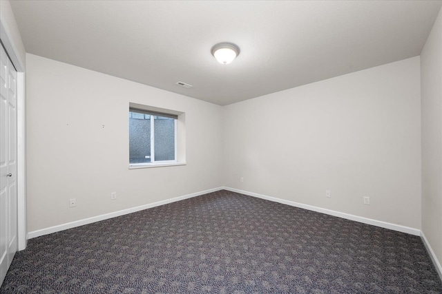 858 S Shelley Lake Ln, Spokane Valley, WA 99037 - unfurnished bedroom featuring dark carpet, baseboards, and a closet