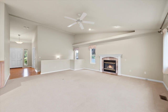 858 S Shelley Lake Ln, Spokane Valley, WA 99037 - unfurnished living room featuring light colored carpet, vaulted ceiling, healthy amount of natural light, a premium fireplace, and baseboards