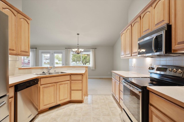 858 S Shelley Lake Ln, Spokane Valley, WA 99037 - kitchen featuring stainless steel appliances, light brown cabinets, a sink, a chandelier, and a peninsula