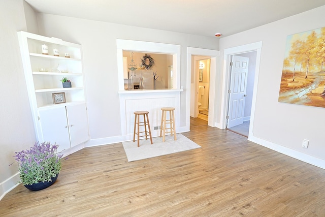 1327 N Howard St, Spokane, WA 99201 - unfurnished living room featuring wood finished floors and baseboards