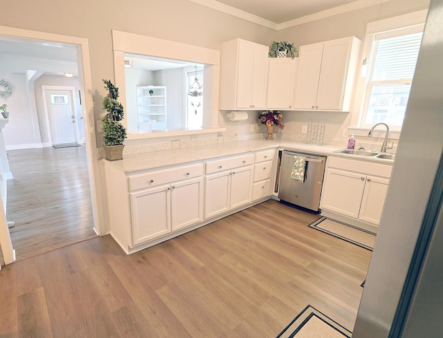 1327 N Howard St, Spokane, WA 99201 - kitchen featuring stainless steel dishwasher, a sink, light wood-style floors, white cabinetry, and light countertops