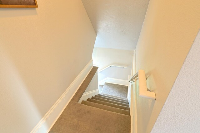 1327 N Howard St, Spokane, WA 99201 - stairs featuring carpet flooring and baseboards