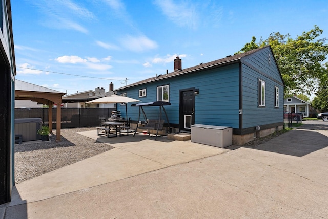 2924 N Smith St, Spokane, WA 99207 - back of house with a hot tub, a chimney, a patio, and a gazebo
