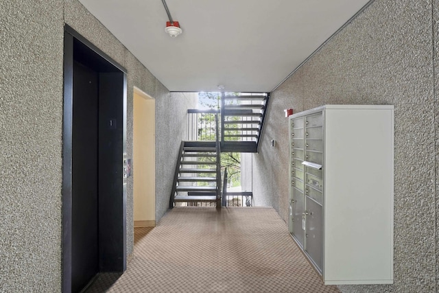 1002 W 7th Ave Unit 203, Spokane, WA 99204 - corridor with elevator, mail area, and carpet flooring