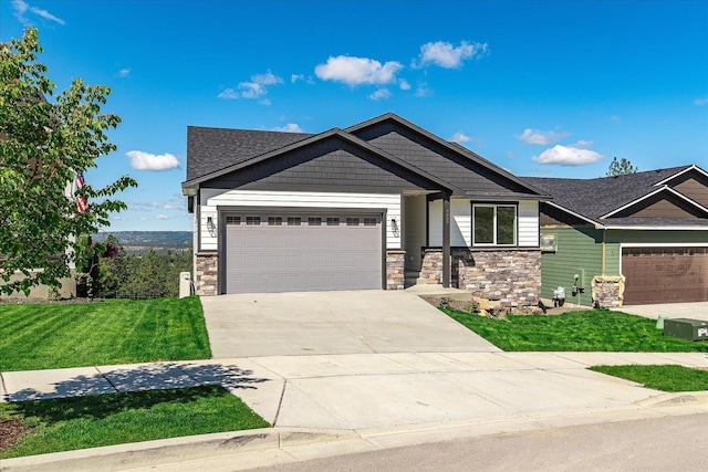 4229 W Tolliver Ct, Spokane, WA 99208 - craftsman inspired home with stone siding, driveway, a front lawn, and a garage