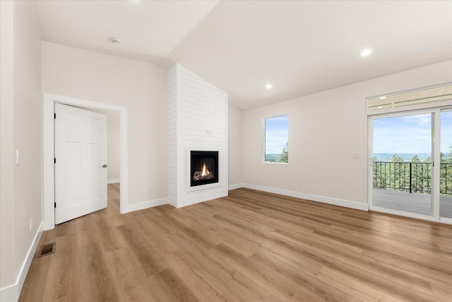 4229 W Tolliver Ct, Spokane, WA 99208 - unfurnished living room featuring light wood finished floors, healthy amount of natural light, baseboards, recessed lighting, and lofted ceiling