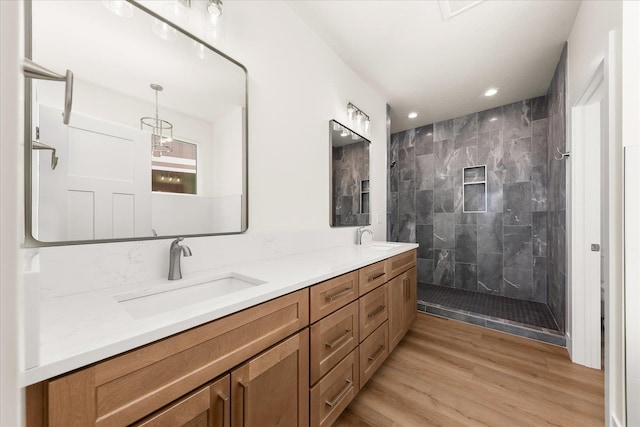 4229 W Tolliver Ct, Spokane, WA 99208 - full bathroom featuring a tile shower, double vanity, recessed lighting, and wood finished floors