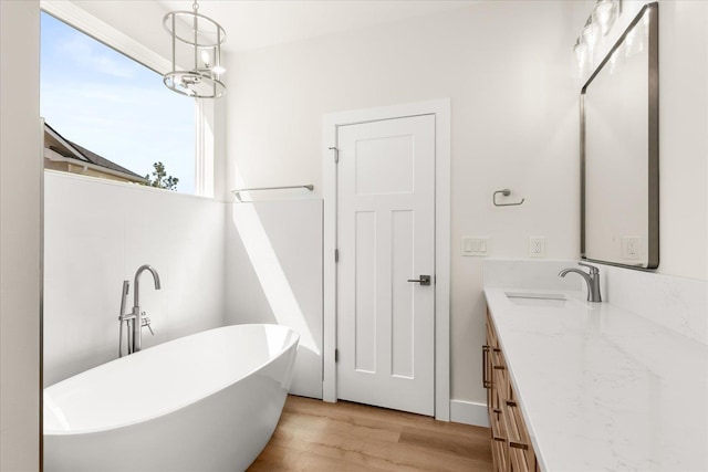 4229 W Tolliver Ct, Spokane, WA 99208 - bathroom with a freestanding tub, double vanity, and wood finished floors