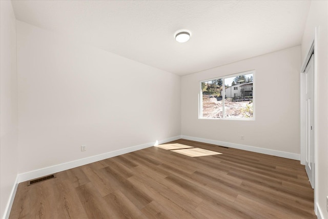 4229 W Tolliver Ct, Spokane, WA 99208 - unfurnished bedroom featuring wood finished floors, baseboards, and a closet