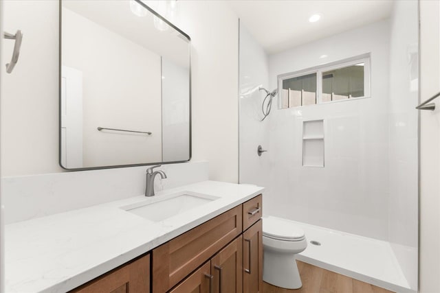 4229 W Tolliver Ct, Spokane, WA 99208 - bathroom with toilet, vanity, a walk in shower, and wood finished floors
