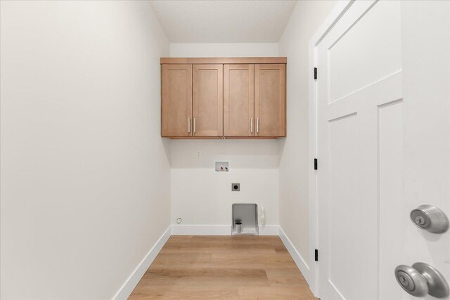 4229 W Tolliver Ct, Spokane, WA 99208 - washroom with light wood finished floors, hookup for an electric dryer, washer hookup, baseboards, and cabinet space