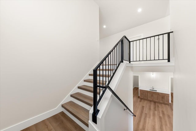4229 W Tolliver Ct, Spokane, WA 99208 - stairs with wood finished floors, wet bar, and recessed lighting