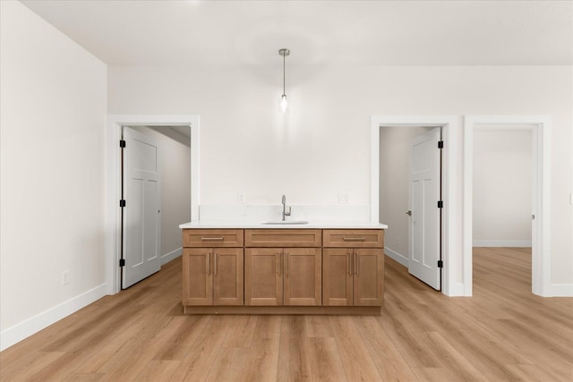 4229 W Tolliver Ct, Spokane, WA 99208 - kitchen featuring a sink, light wood-style flooring, light countertops, and baseboards