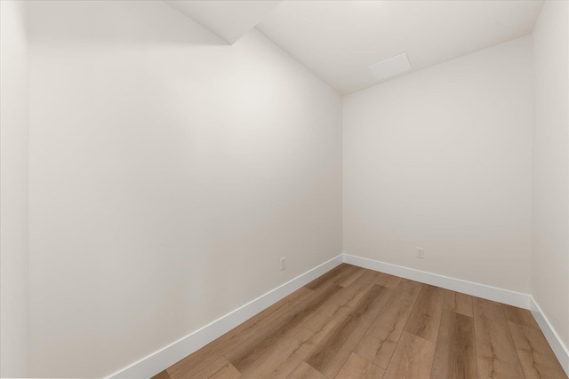 4229 W Tolliver Ct, Spokane, WA 99208 - spare room featuring baseboards, light wood-style floors, and vaulted ceiling