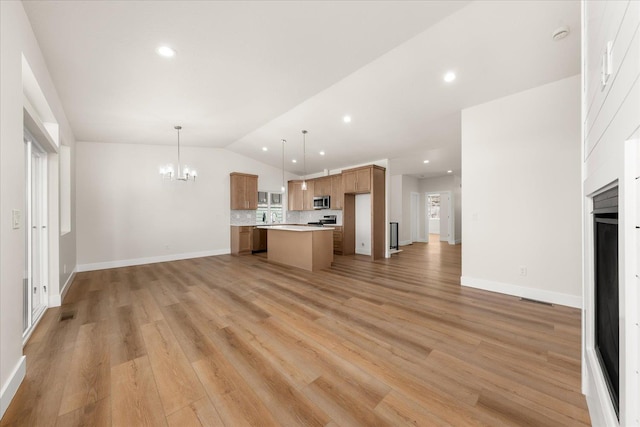 4229 W Tolliver Ct, Spokane, WA 99208 - unfurnished living room featuring lofted ceiling, a chandelier, light wood finished floors, baseboards, and recessed lighting