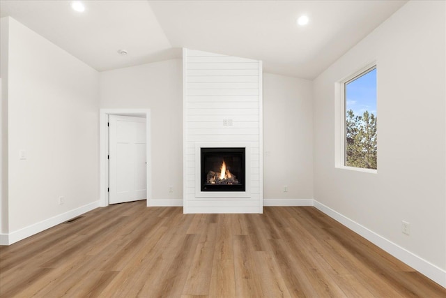 4229 W Tolliver Ct, Spokane, WA 99208 - unfurnished living room with vaulted ceiling, a large fireplace, baseboards, light wood-style floors, and recessed lighting
