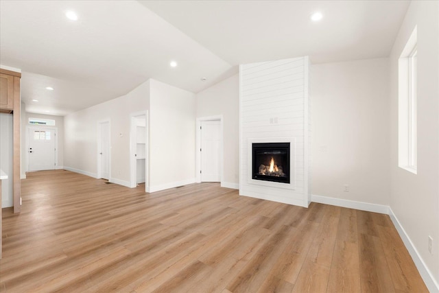 4229 W Tolliver Ct, Spokane, WA 99208 - unfurnished living room featuring light wood finished floors, a large fireplace, recessed lighting, baseboards, and vaulted ceiling