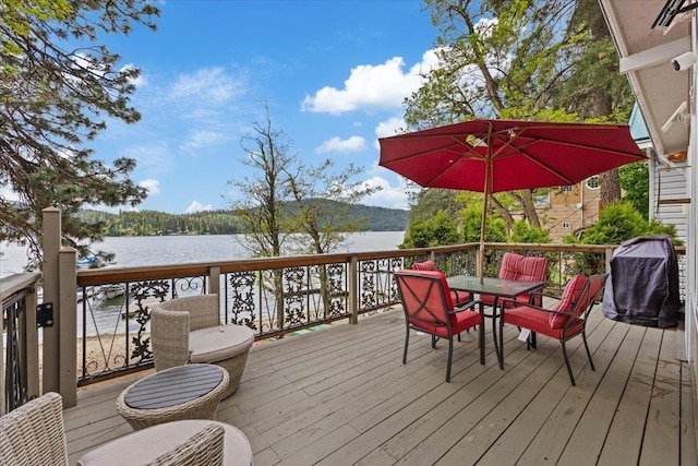 12931 N N Park St, Newman Lake, WA 99006 - wooden terrace with a water view, outdoor dining area, and a grill