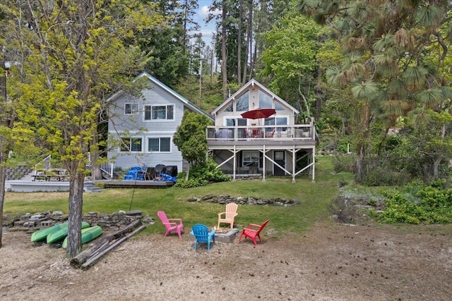 12931 N N Park St, Newman Lake, WA 99006 - back of property with a fire pit, a wooden deck, and a yard
