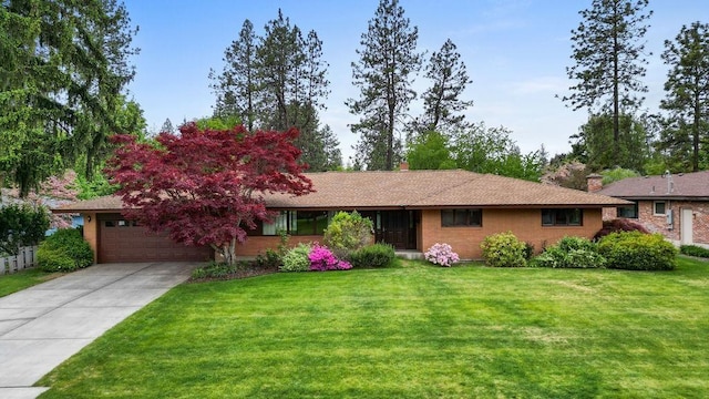 4504 S Madelia St, Spokane, WA 99223 - ranch-style house featuring driveway, a front yard, an attached garage, and a chimney
