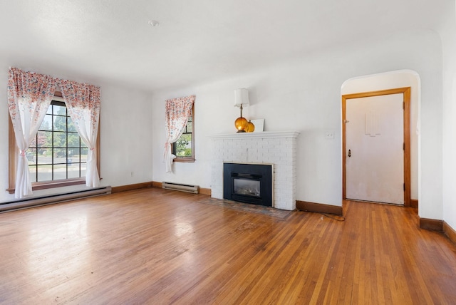 106 E 29th Avenue Corner Of 29Th & Tekoa - Entry & Garage On Tekoa, Spokane, WA 99203 - unfurnished living room featuring baseboard heating, hardwood / wood-style flooring, a fireplace, and baseboards