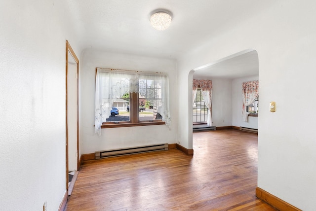 106 E 29th Avenue Corner Of 29Th & Tekoa - Entry & Garage On Tekoa, Spokane, WA 99203 - unfurnished room featuring arched walkways, baseboard heating, wood finished floors, and baseboards