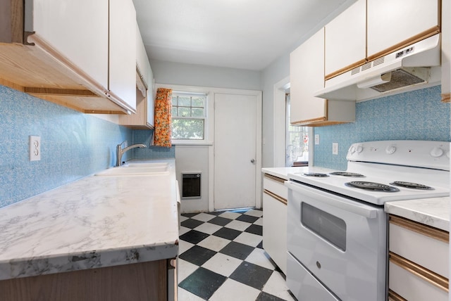 106 E 29th Avenue Corner Of 29Th & Tekoa - Entry & Garage On Tekoa, Spokane, WA 99203 - kitchen with white range with electric cooktop, under cabinet range hood, light flooring, a sink, and light countertops