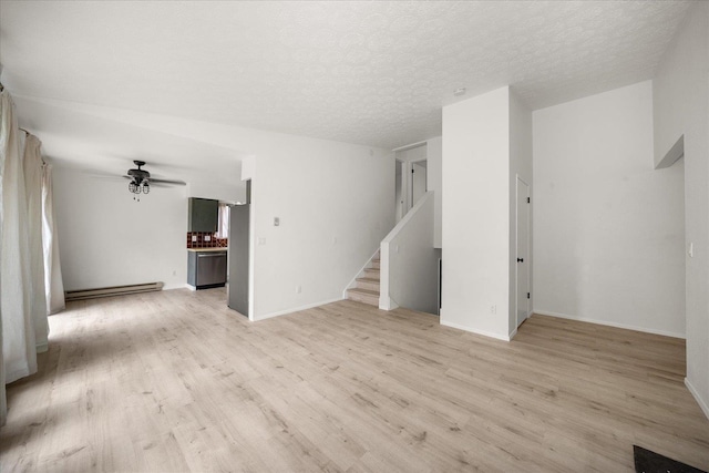 20716 E Gilbert Rd, Otis Orchards, WA 99027 - unfurnished living room featuring a baseboard heating unit, light wood-style floors, stairs, a ceiling fan, and a textured ceiling