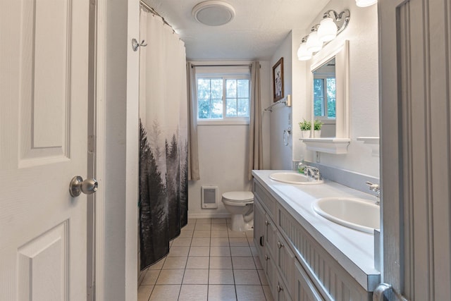 8431 Fertile Valley Rd, Newport, WA 99156 - bathroom with tile patterned floors, double vanity, and toilet