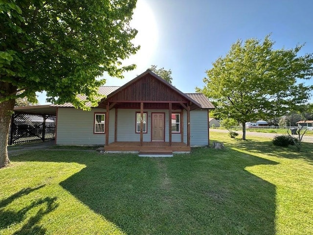 302 S Center St, Chewelah, WA 99109 - view of front of property with covered porch, metal roof, a front lawn, and a carport