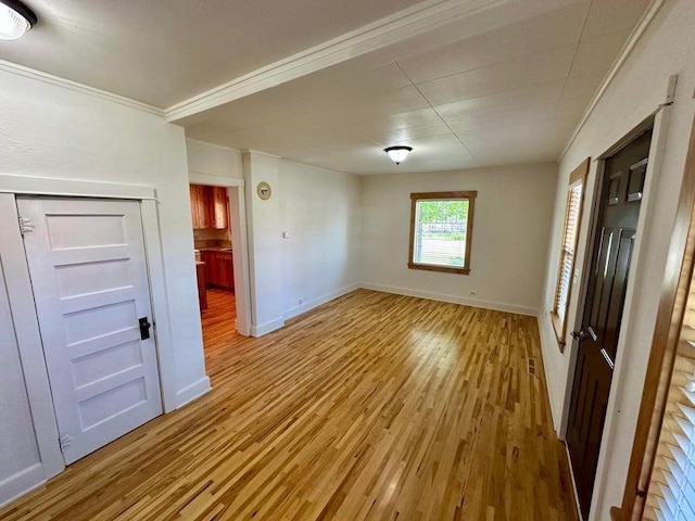 302 S Center St, Chewelah, WA 99109 - empty room with light wood-type flooring, baseboards, and ornamental molding