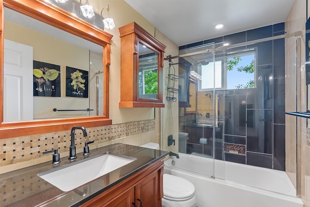 4022 E 25th Ave, Spokane, WA 99223 - full bath with toilet, vanity, backsplash, and combined bath / shower with glass door