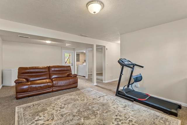 4022 E 25th Ave, Spokane, WA 99223 - workout area featuring carpet, washer / dryer, baseboards, and a textured ceiling