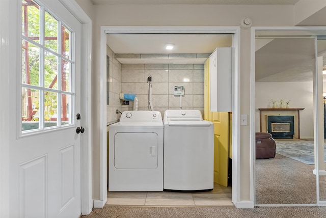 4022 E 25th Ave, Spokane, WA 99223 - laundry area featuring plenty of natural light, washing machine and clothes dryer, and a glass covered fireplace