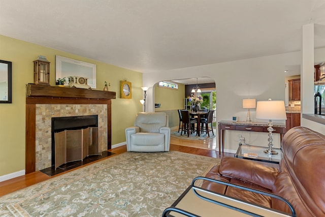 4022 E 25th Ave, Spokane, WA 99223 - living room with arched walkways, wood finished floors, baseboards, and a fireplace