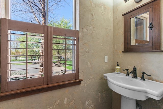 1467 E Lacey Ave, Hayden, ID 83835 - bathroom with a textured wall, plenty of natural light, and a sink