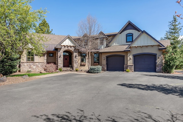 1467 E Lacey Ave, Hayden, ID 83835 - view of front of home featuring stone siding, board and batten siding, asphalt driveway, and a garage