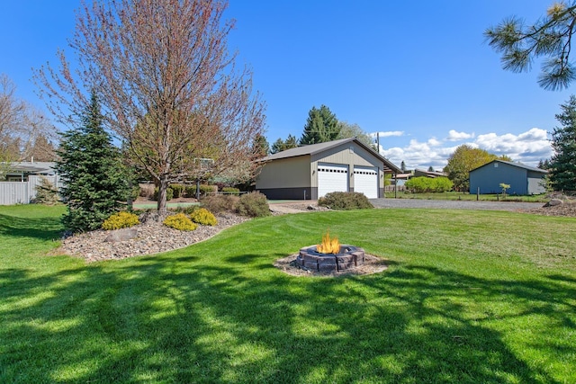 1467 E Lacey Ave, Hayden, ID 83835 - view of yard featuring a fire pit, a garage, and an outdoor structure