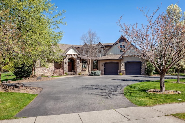 1467 E Lacey Ave, Hayden, ID 83835 - view of front of property with stone siding, driveway, an attached garage, and board and batten siding