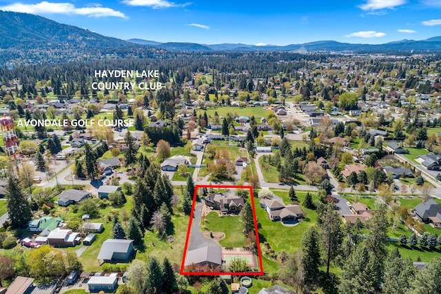 1467 E Lacey Ave, Hayden, ID 83835 - aerial view of residential area with a mountain backdrop and property parcel outlined